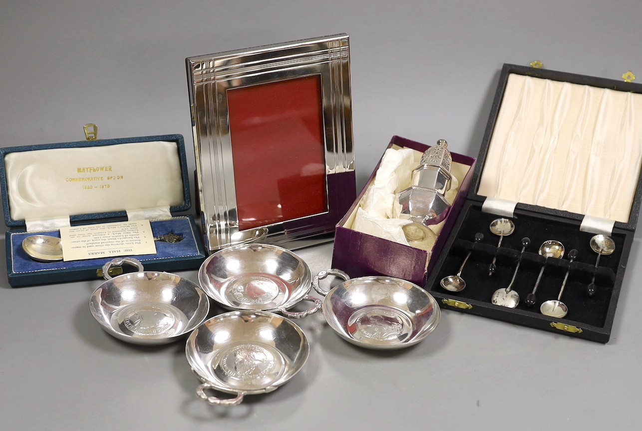 A George I silver octagonal caster, Thomas Bamford, London, 1725, 13.1cm, a cased modern silver commemorative spoon, a cased set of six silver bean end coffee spoons and five plated items.